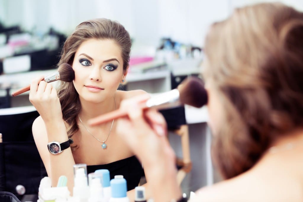 Woman applying rouge