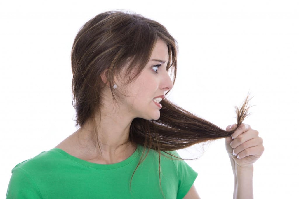 Shocked and sad woman - broken hair after coloration.